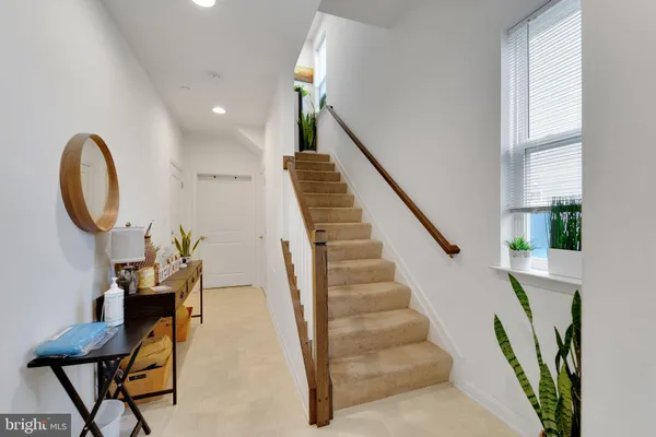 a view of entryway and hall with wooden floor
