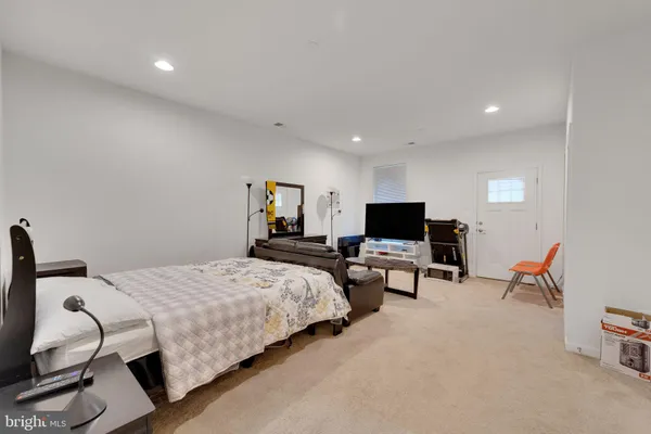 a bedroom with bed and a couch