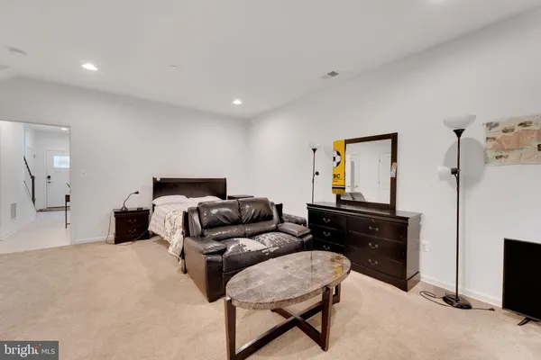 a bedroom with a bed and a dresser