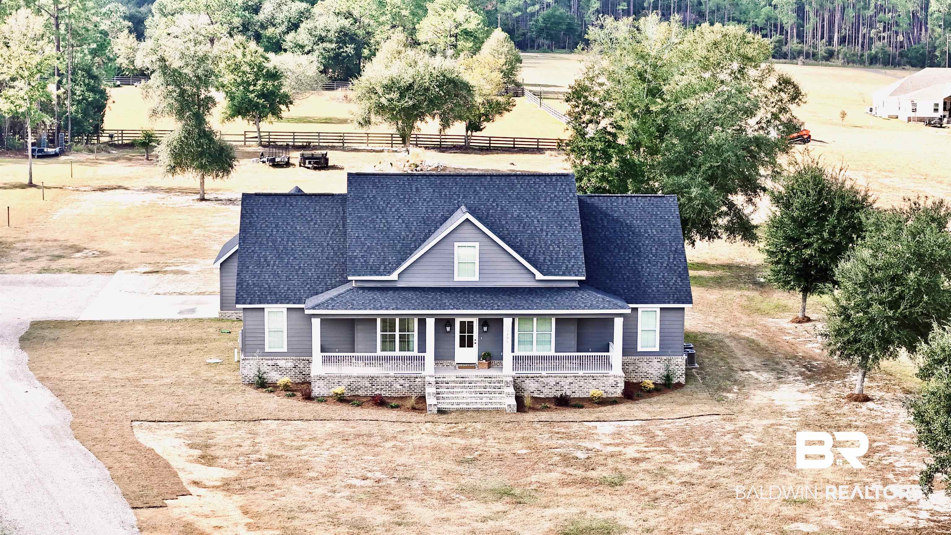 View of front of house with a shingled roof and a porch