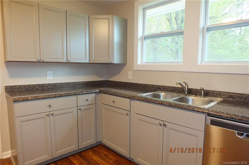 288 South Potter Road Lancaster, SC 29720 - Photo 7 of 24 a kitchen with granite countertop white cabinets and sink