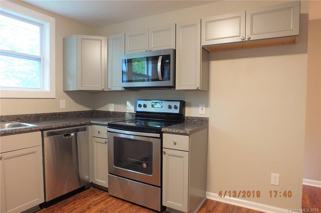 288 South Potter Road Lancaster, SC 29720 - Photo 8 of 24 a kitchen with stainless steel appliances granite countertop a stove and a microwave