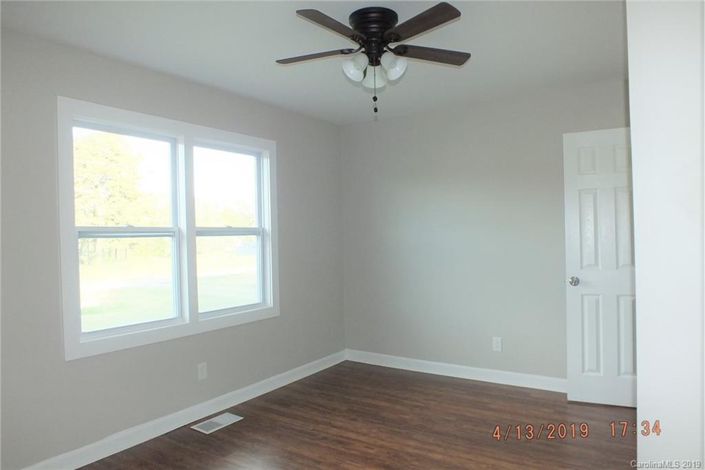 288 South Potter Road Lancaster, SC 29720 - Photo 10 of 24 an empty room with wooden floor fan and windows