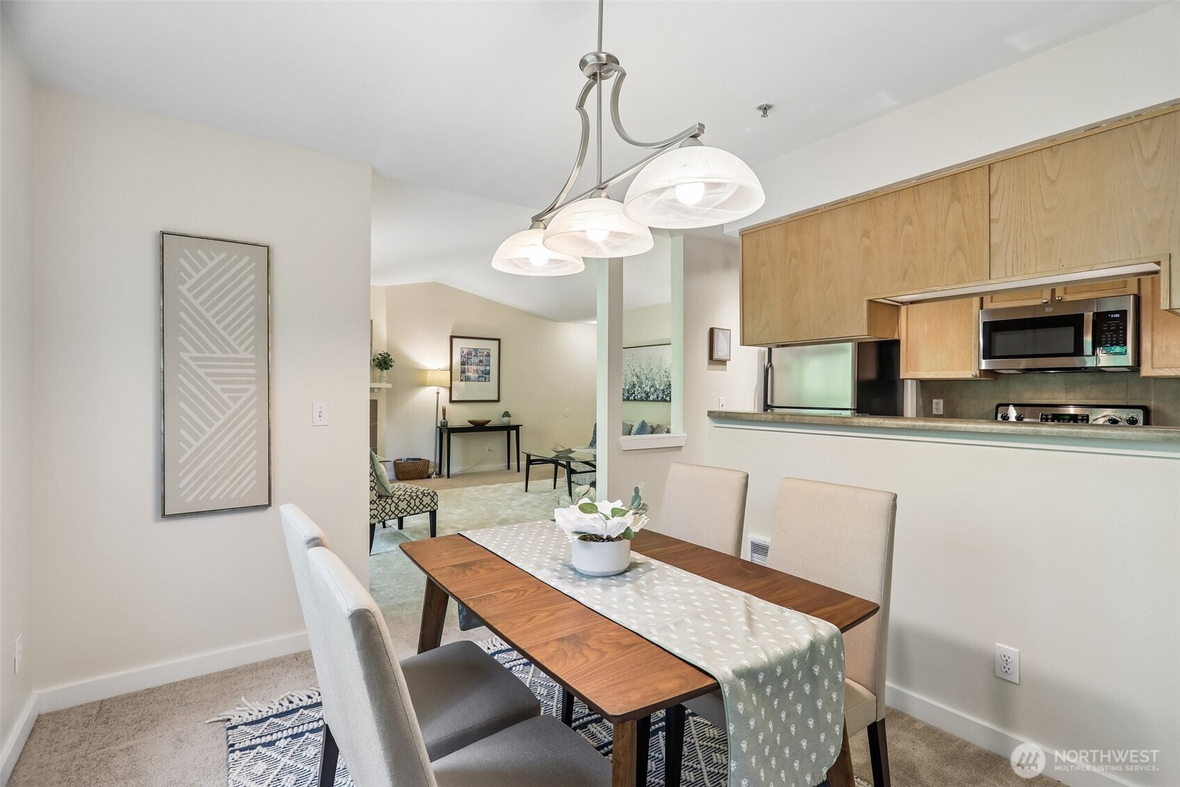 18930 Bothell Everett Highway, Unit E301 Bothell, WA 98012 - Photo 8 of 28 a view of a dining room with furniture and wooden floor