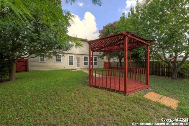 a view of a house with backyard and porch