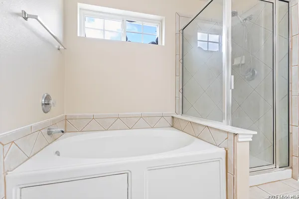 a bathroom with a bathtub and shower