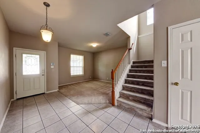 a view of entryway with stairs and wooden floor