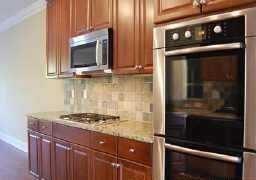 2436 Dresden Parc Circle Atlanta, GA 30345 - Photo 4 of 17 a kitchen with granite countertop a stove and a microwave