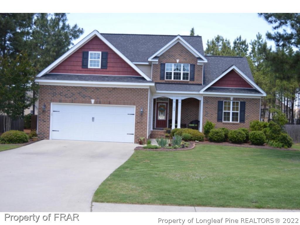 103 Sandy Springs Road Aberdeen, NC 28315 - Photo 1 of 25 a front view of a house with a yard and garage