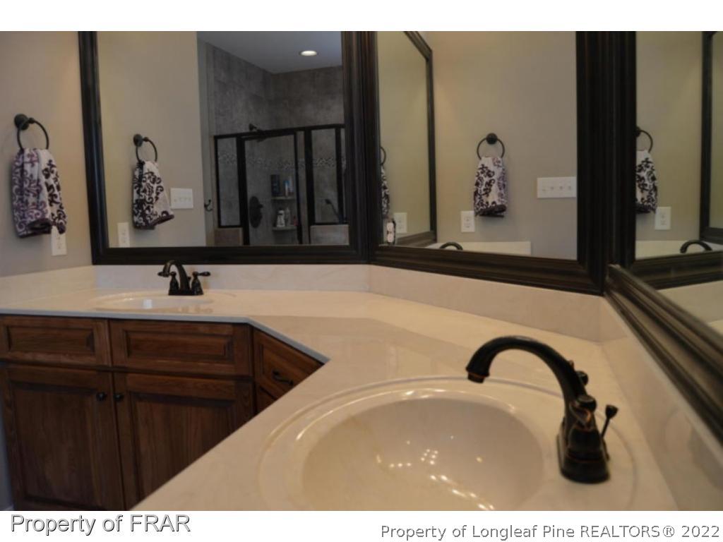 103 Sandy Springs Road Aberdeen, NC 28315 - Photo 13 of 25 a bathroom with a sink and a mirror