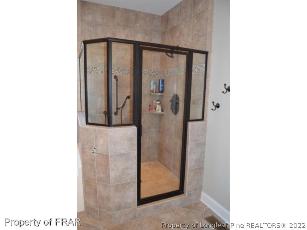 103 Sandy Springs Road Aberdeen, NC 28315 - Photo 14 of 25 a bathroom with a mirror