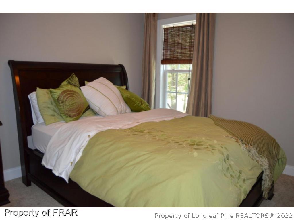 103 Sandy Springs Road Aberdeen, NC 28315 - Photo 18 of 25 a large bed sitting in a bedroom next to a window