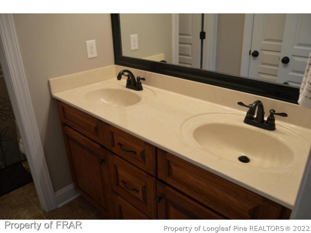 103 Sandy Springs Road Aberdeen, NC 28315 - Photo 20 of 25 a bathroom with a sink and a mirror
