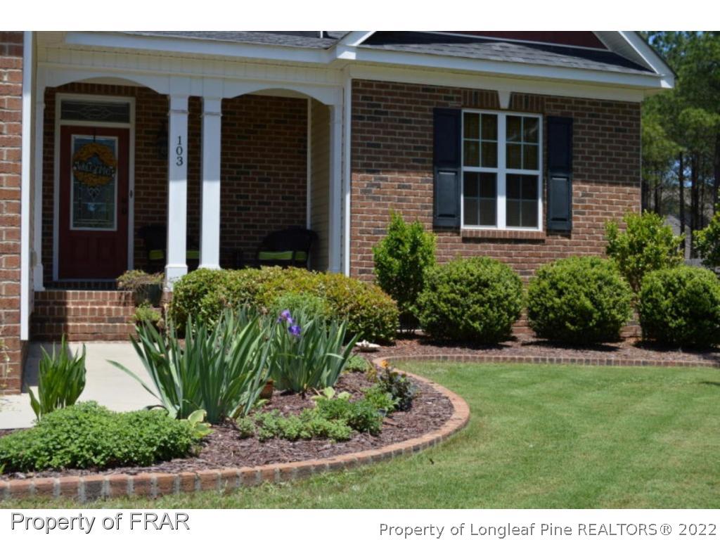 103 Sandy Springs Road Aberdeen, NC 28315 - Photo 2 of 25 a view of a house with potted plants and a yard
