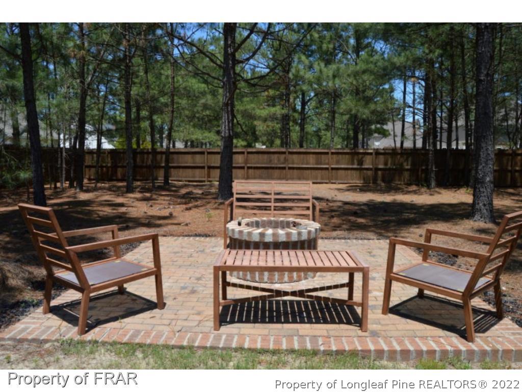 103 Sandy Springs Road Aberdeen, NC 28315 - Photo 23 of 25 a view of a backyard with sitting area