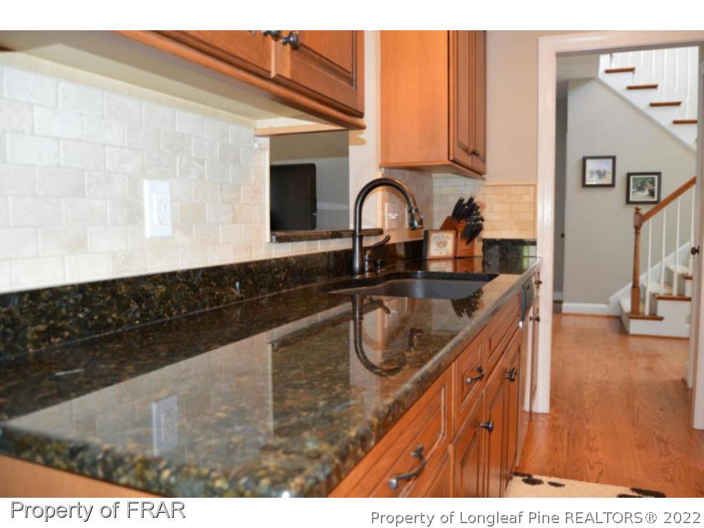 103 Sandy Springs Road Aberdeen, NC 28315 - Photo 4 of 25 a kitchen with sink a stove and cabinets
