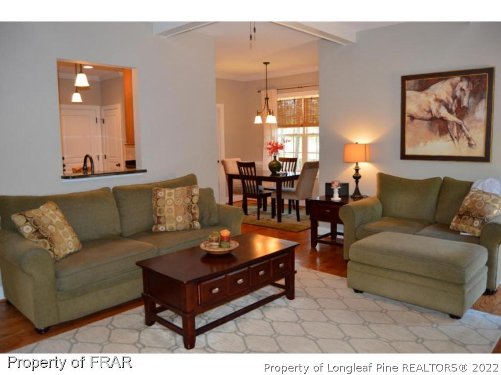 103 Sandy Springs Road Aberdeen, NC 28315 - Photo 9 of 25 a living room with furniture and a chandelier