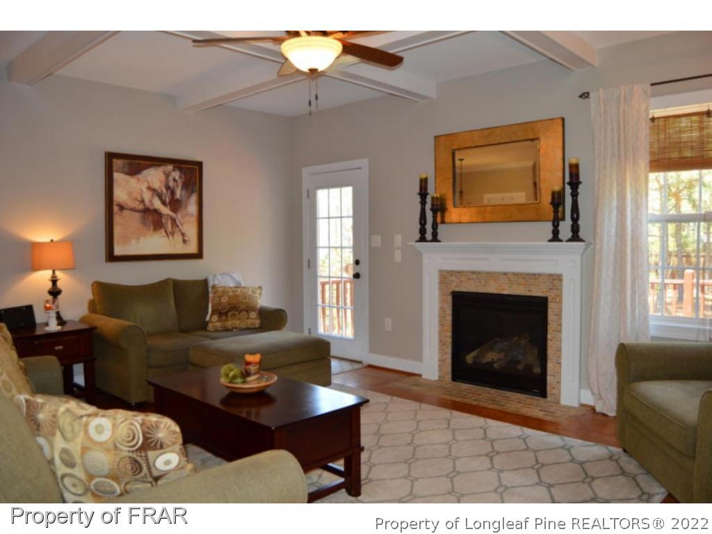 103 Sandy Springs Road Aberdeen, NC 28315 - Photo 10 of 25 a living room with furniture and a fireplace