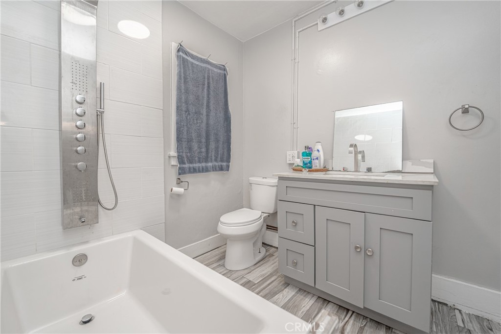 430 Rose Avenue Long Beach, CA 90802 - Photo 18 of 20 a bathroom with a tub sink toilet and a mirror