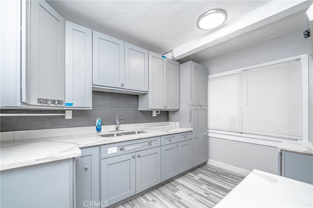 430 Rose Avenue Long Beach, CA 90802 - Photo 6 of 20 a kitchen with a sink and cabinets
