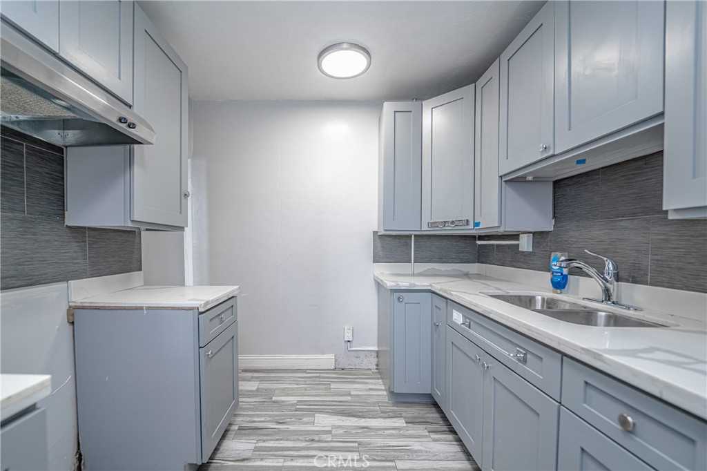 430 Rose Avenue Long Beach, CA 90802 - Photo 7 of 20 a kitchen with a sink cabinets and window
