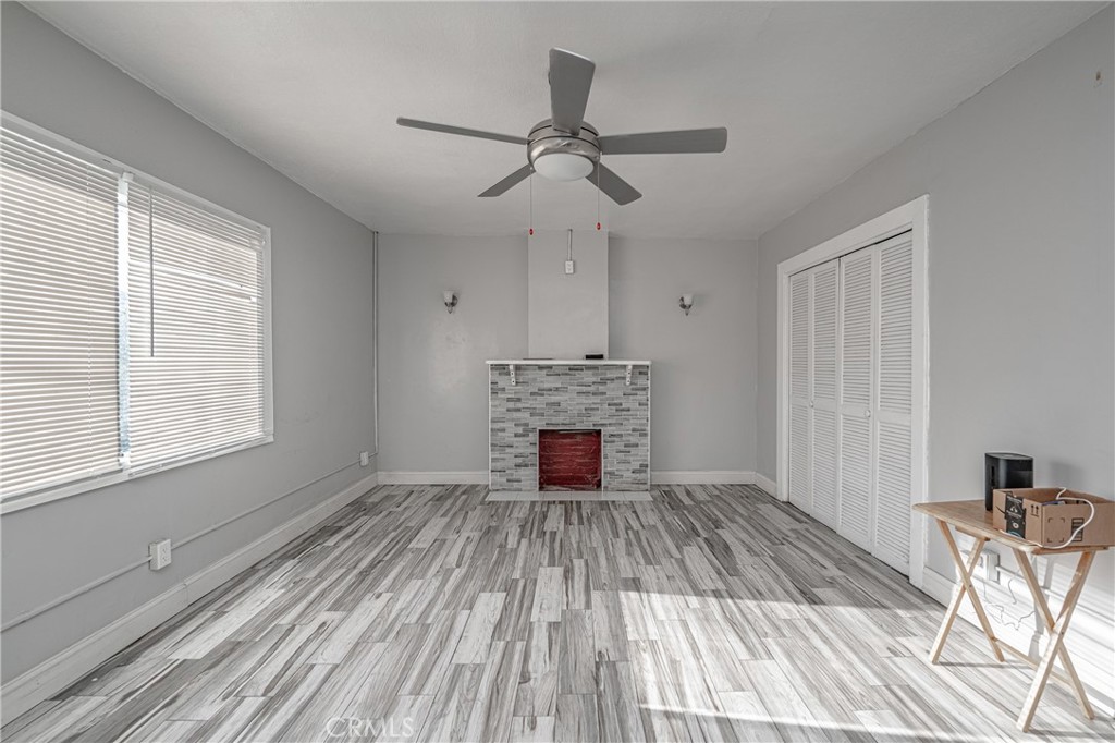 430 Rose Avenue Long Beach, CA 90802 - Photo 9 of 20 a view of empty room with wooden floor fireplace and windows