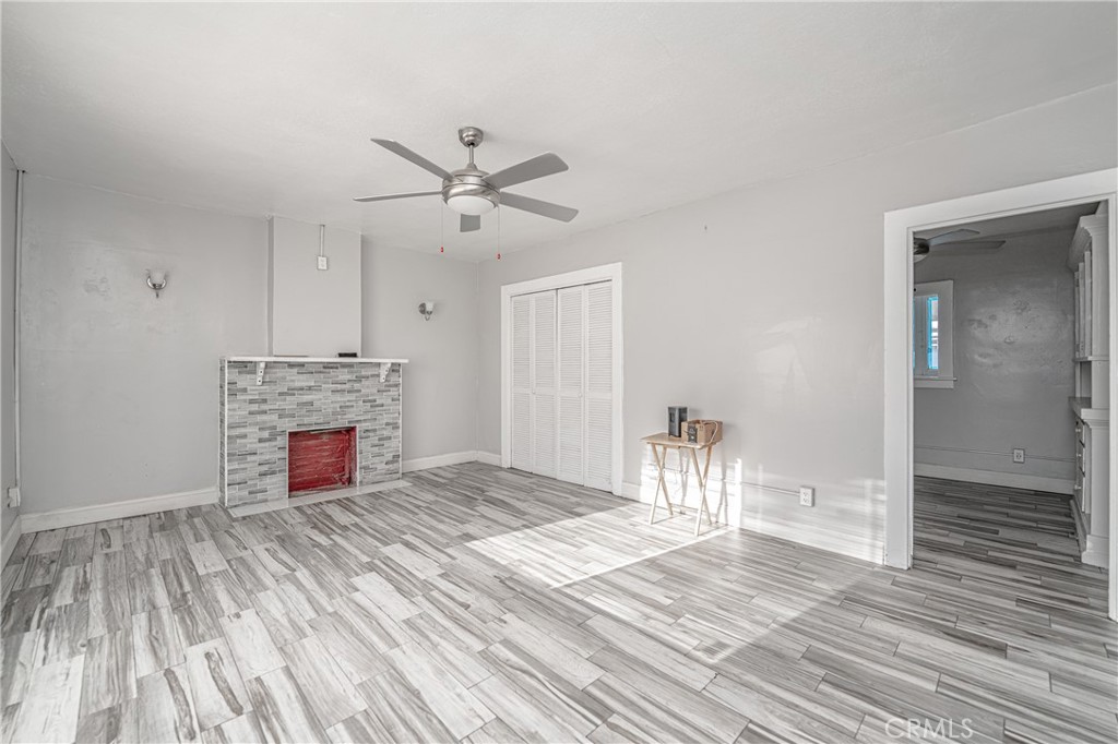 430 Rose Avenue Long Beach, CA 90802 - Photo 10 of 20 a view of a livingroom with a fireplace a chandelier and wooden floor