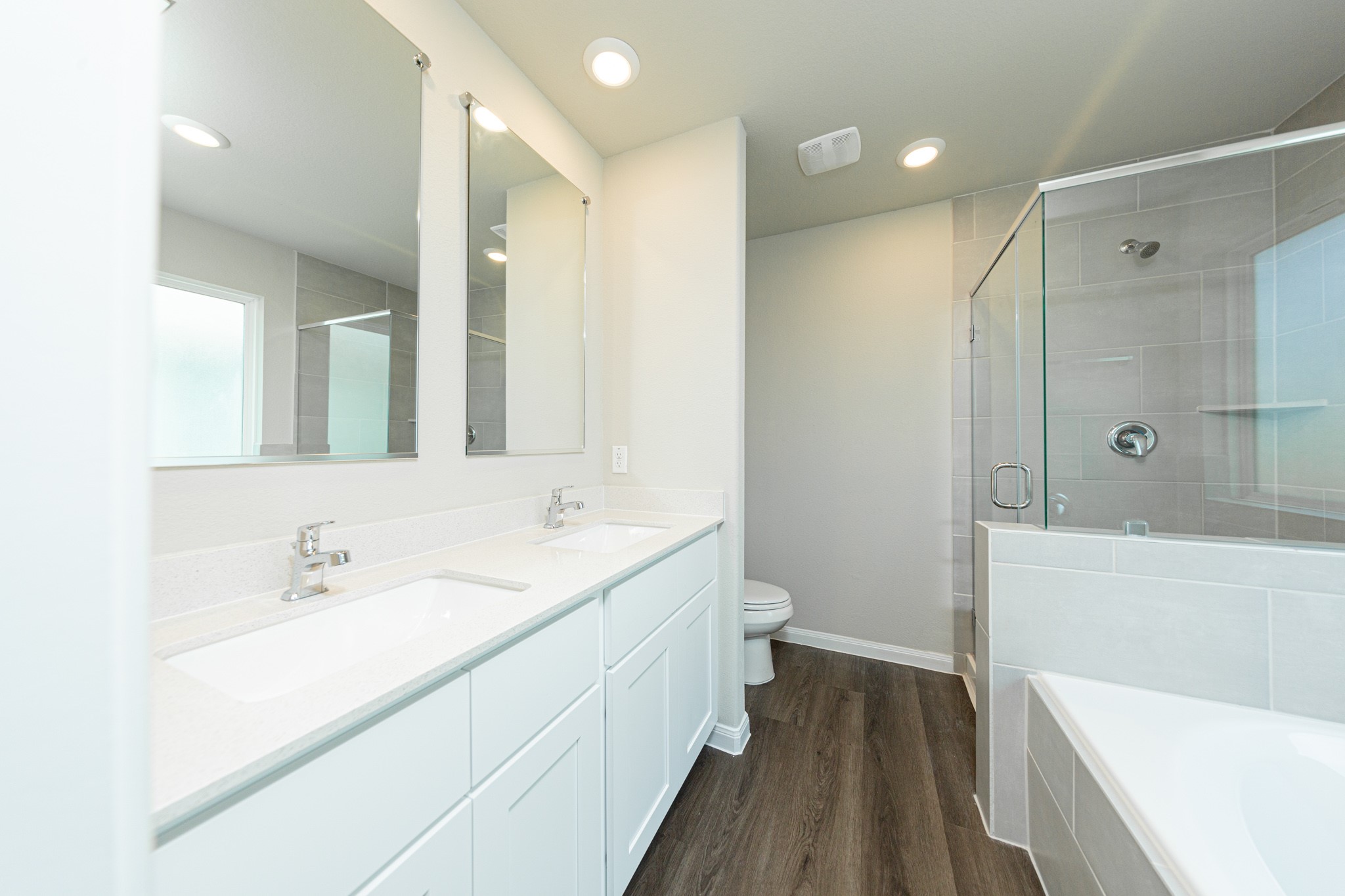 13654 Kit Run Splendora, TX 77372 - Photo 10 of 24 a spacious bathroom with a double vanity sink a toilet and a bathtub
