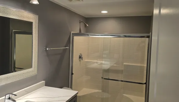 a bathroom with a shower a toilet and sink