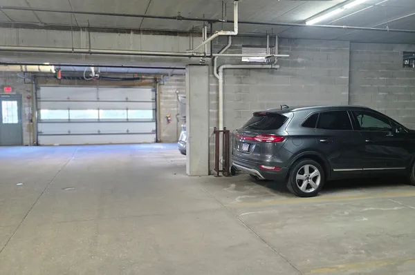 a view of garage with a car parked in it