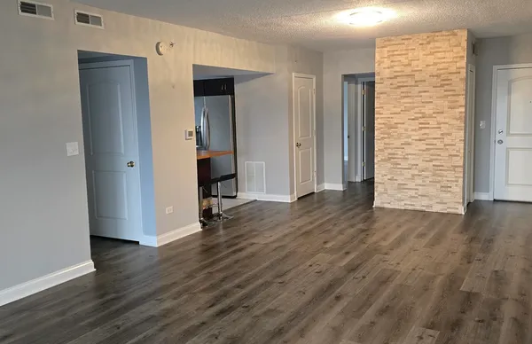 an empty room with wooden floor and closet