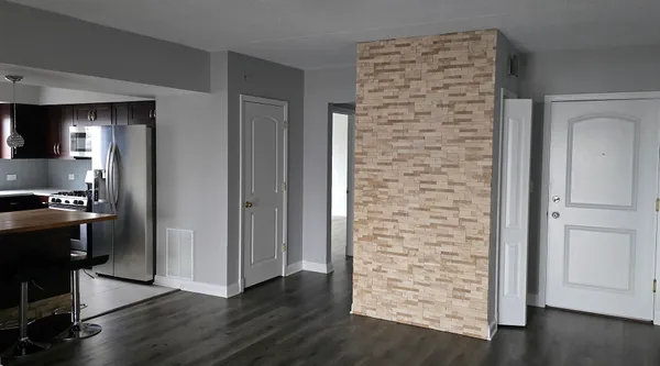 wooden floor in an empty room and a kitchen