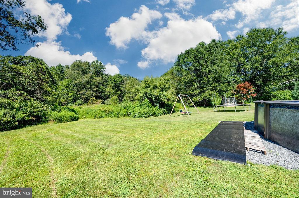 881 Zion Road Mohnton, PA 19540 - Photo 52 of 64 Spacious yard with lush greenery and swings.