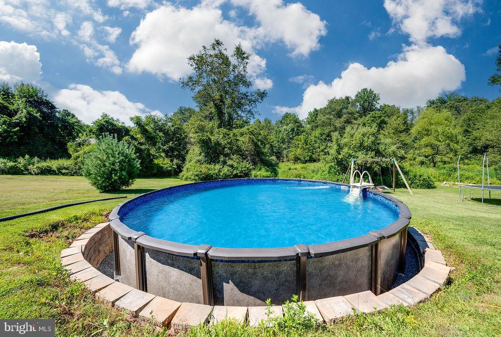 881 Zion Road Mohnton, PA 19540 - Photo 61 of 64 Inviting pool surrounded by lush greenery.