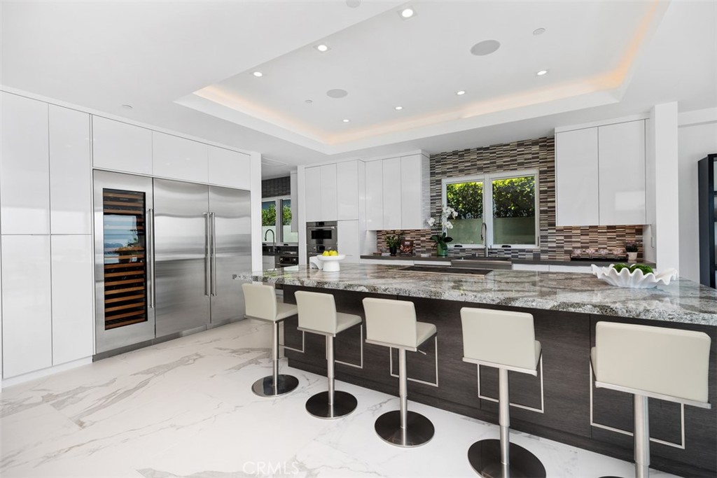 67 Monarch Bay Drive Dana Point, CA 92629 - Photo 17 of 44 a kitchen with stainless steel appliances kitchen island granite countertop a sink and cabinets