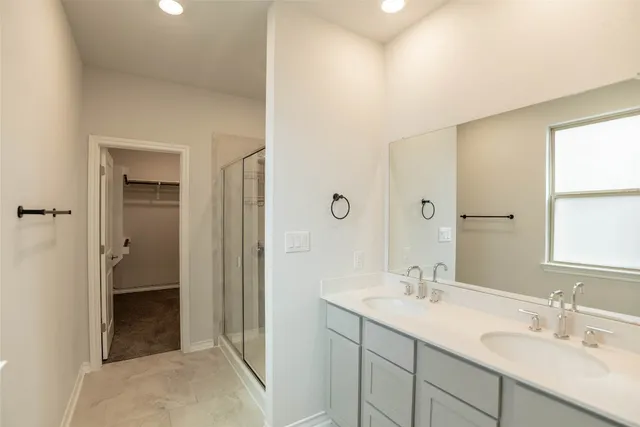 a bathroom with 2 sink and a mirror