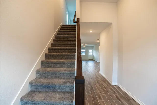 a view of a hallway with wooden floor and entryway