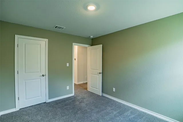 an empty room with closet area