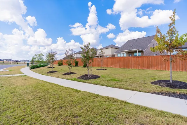a view of a swimming pool with a yard