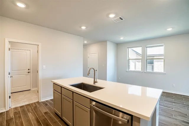a kitchen with a sink a refrigerator and window