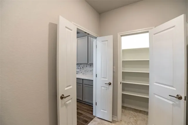 a view of walk in closet with empty racks