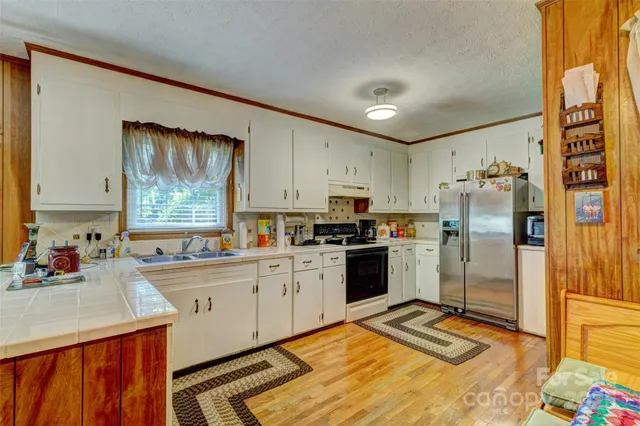 a kitchen with a sink stove and refrigerator