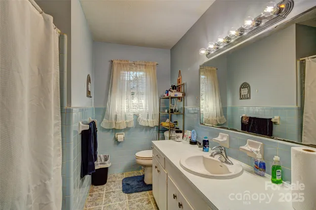 a spacious bathroom with a sink double vanity and a mirror