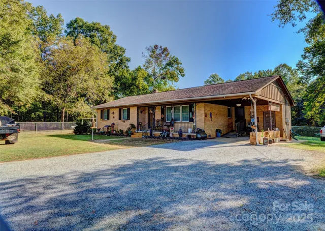 a view of a house with a yard and sitting area