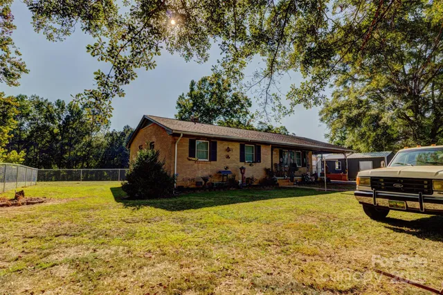 a view of a house with swimming pool and sitting area