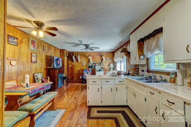a large white kitchen with a large window