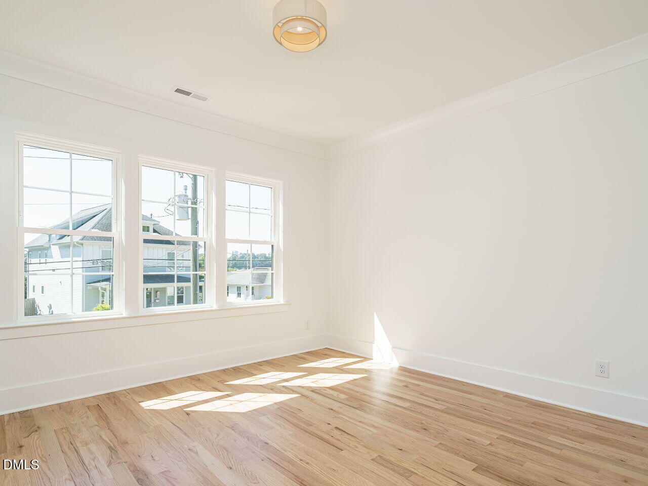 627 Georgetown Road Raleigh, NC 27608 - Photo 34 of 44 an empty room with wooden floor and windows
