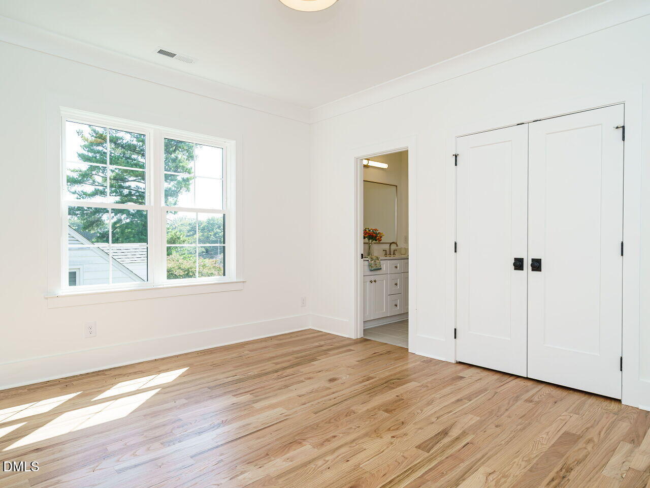 627 Georgetown Road Raleigh, NC 27608 - Photo 38 of 44 a view of empty room with wooden floor and fan