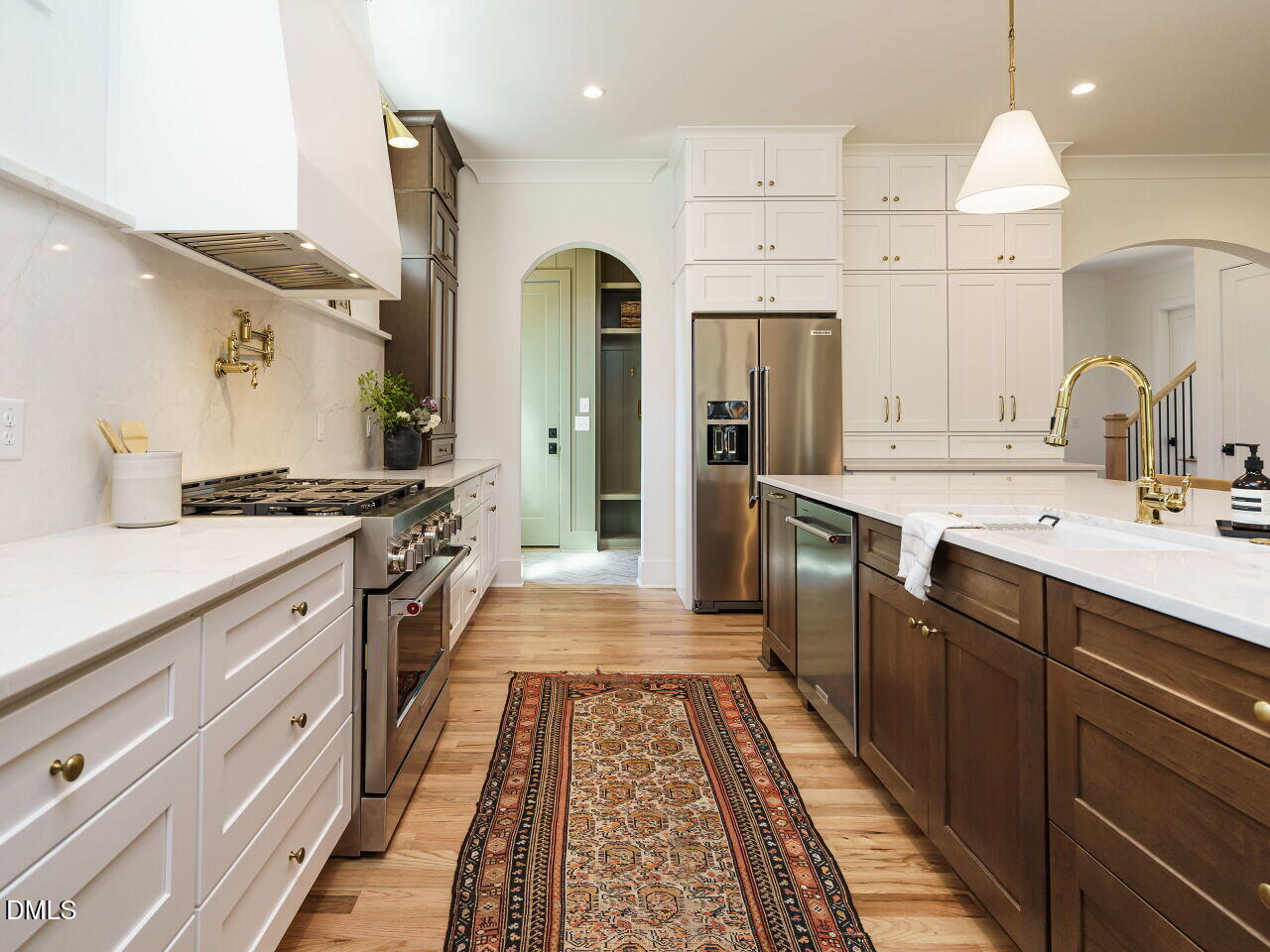 627 Georgetown Road Raleigh, NC 27608 - Photo 4 of 44 a large kitchen with stainless steel appliances a stove a sink dishwasher and a refrigerator with wooden floor