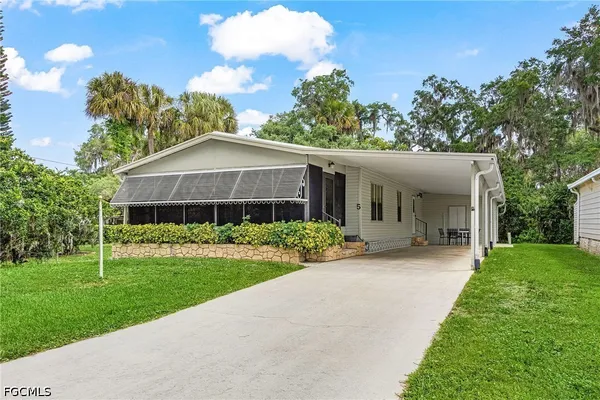 a front view of a house with a yard and porch